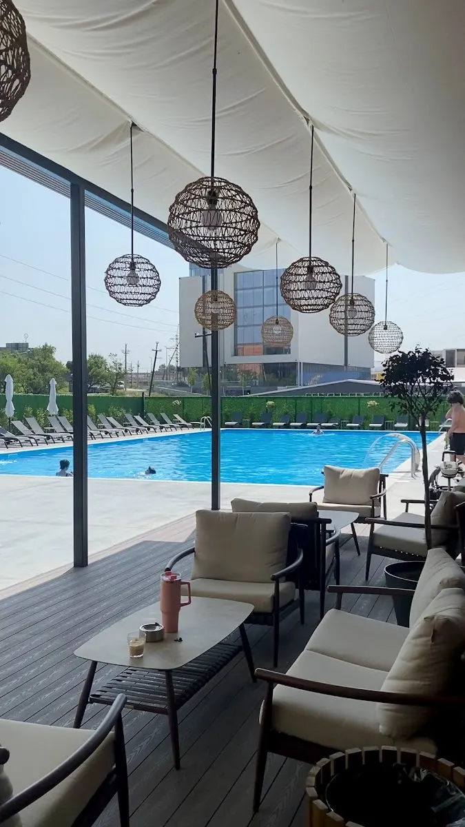 Lisi Pool — open-air pool with covered lounge area, right next to Sports Park